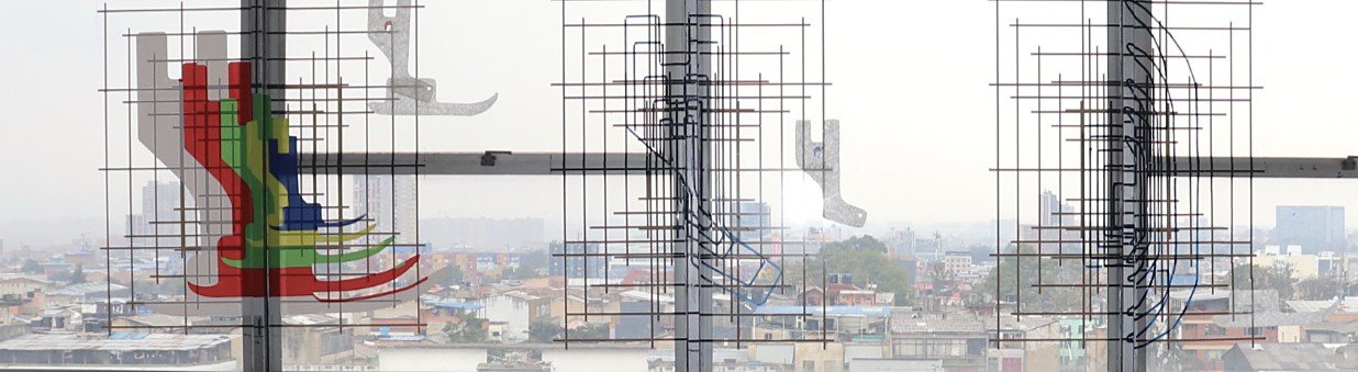 Cartografías Minerva 1: dibujo técnico de pies de máquina de coser sobre una ventana del edificio Telecom, con Bogotá al fondo